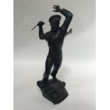 A cast iron figure of a sailor, possibly Russian, modelled in attacking posture with knife raised in