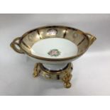 A Japanese Noritake porcelain fruit bowl on stand, the centre decorated with flowers and with twin