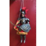 An Italian carved wooden and metal rod puppet of a knight 'Orlando', with red feathered plumed