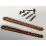 Three various police / military whistles, together with two wooden truncheons, one marked 857A