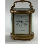 A Garrard & Co. ltd. brass carriage clock, of oval form, the top with exposed platform escapement,