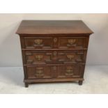 A William & Mary English Oak chest of three, long panelled drawers with brass handles and