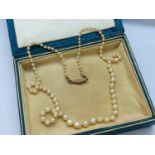 A lady's pearl necklace, graduated pearls from 7mm to 2mm, gold clasp with faceted sapphire,