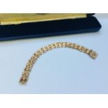 A 9ct gold articulated bracelet in blue fitted box weighing 14.8 grams.