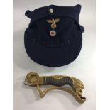 A WW2 Nazi German M-43 navy blue woollen cap, together with a broken lion-pommel hilt from a