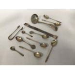 A small collection of assorted silver items comprising apostle teaspoons, a tea sifter and a