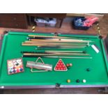 A half-size billiard/snooker table, with green baize top and slate bed, raised on wooden frame and