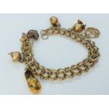 A 9ct yellow gold wire link bracelet with 6 x charms including a mouse, a duck and a teapot,