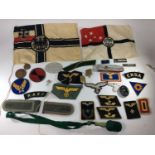 A collection of Nazi, WW2 and Imperial German insignia, cloth patches in a WW2 German grey metal