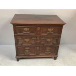 A late 17th century oak chest of two short, over three long graduated drawers with original brass