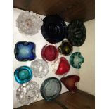 SECTION 23 & 24. Two shelves of coloured glass ashtrays and candle holders including Orrefors and