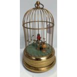A West German singing bird automaton modelled as two birds housed in a gilt brass, domed top cage