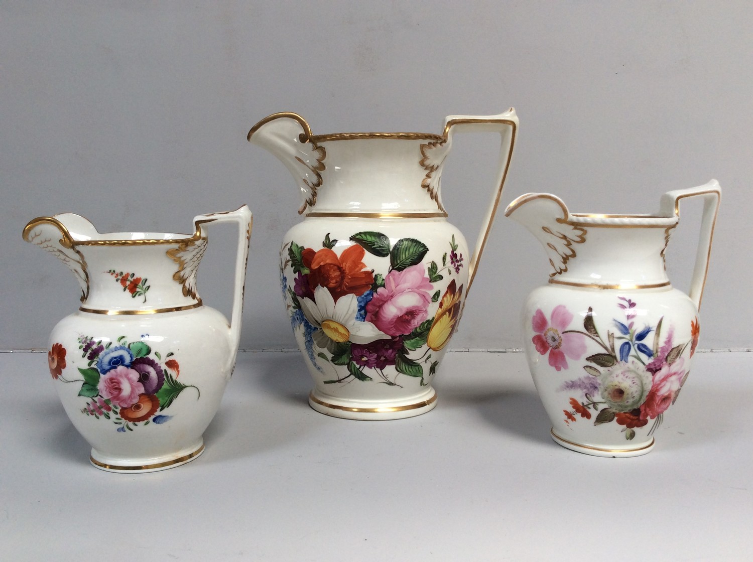 Three various early 19th century English porcelain jugs, probably Staffordshire, with ovoid body and
