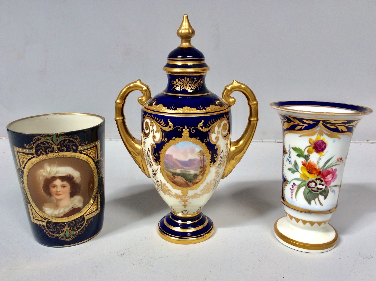 A Royal Vienna porcelain beaker painted with a portrait of a young lady, to a blue ground with