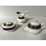 A Chamberlains Worcester teapot of oval form with spiral fluted body, decorated with gilding and