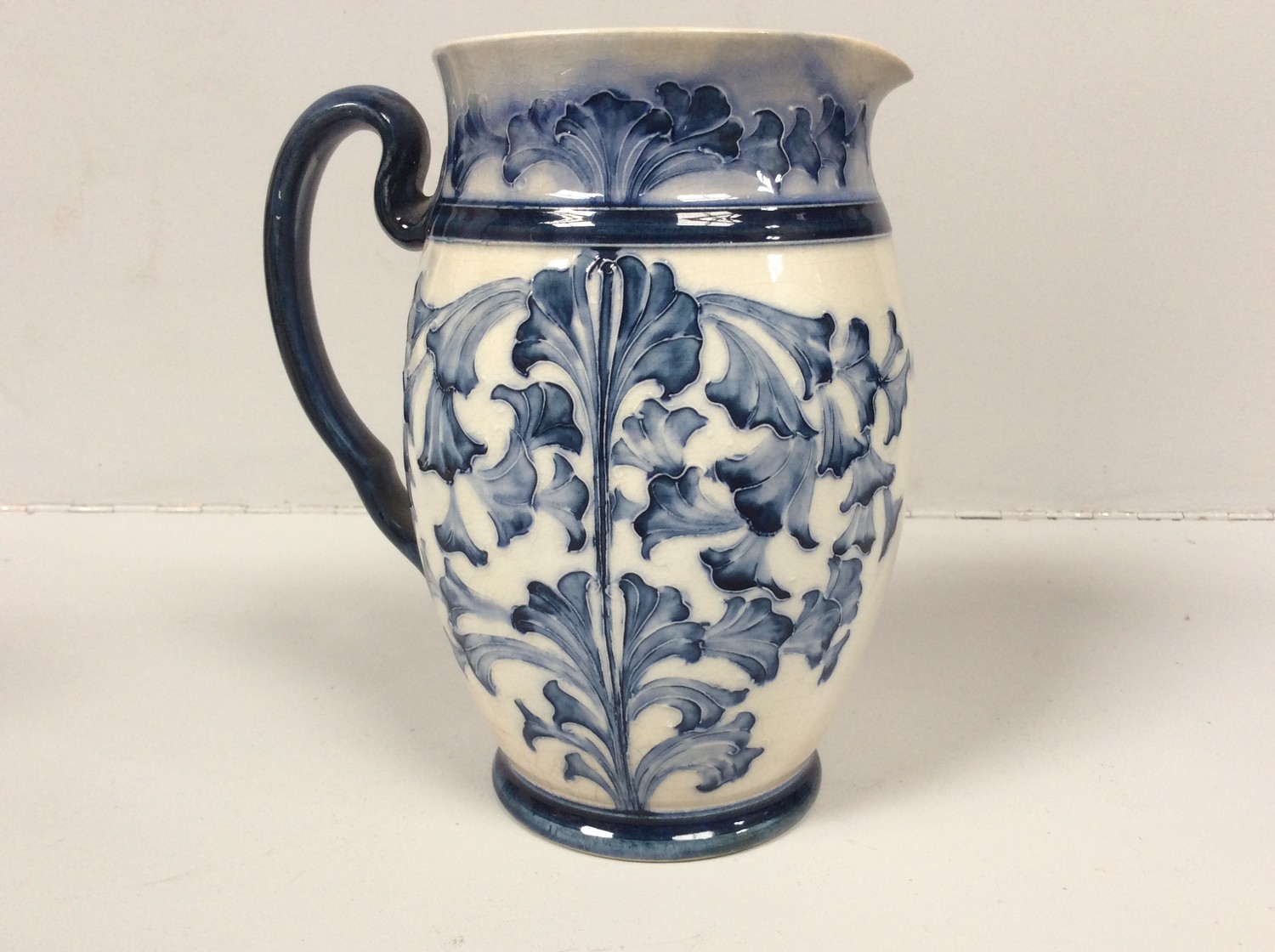 A Macintyre Florian Ware pottery jug with tube-lined and blue glazed floral decoration, Reg No.