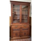 An Edwardian mahogany display bookcase with fixed pediment to the top, pair of glazed doors