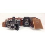 A Zeiss Ikon Super Ikonta folding camera no. 999282 in brown leather case, together with a