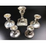 A pair of silver loaded squat candlesticks, Birmingham, 1930, maker's mark of S Blanckensee & Son