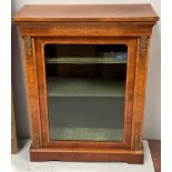A Victorian inlaid walnut pier cabinet with glass fronted door, brass decorative mounts and velour