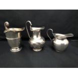 An art nouveau silver milk jug with embossed stylised 'S' continuous scene to lower half,