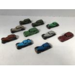A collection of 10 assorted playworn Dinky cars including a Packard in green and a Buick in deep red