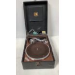 An His Masters Voice portable gramophone in black rexine case, together with a framed Widdicombe
