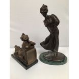 A bronze figure of a lady golfer with hat and long flowing skirt, on oval base raised on green