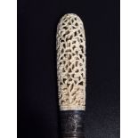 An early 20th century oriental carved ivory letter opener/ page turner, with ivory blade and white