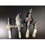 Four various silver and mother of pearl babies rattles including one in the form of Mr Punch,