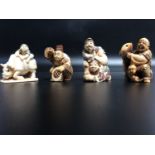 Four early 20th century Japanese carved and stained ivory netsuke, each signed