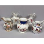 Five various 19th century Staffordshire porcelain jugs with hand-painted polychrome floral