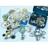 A large quantity of costume jewellery including various stone set brooches, silver rings, silver