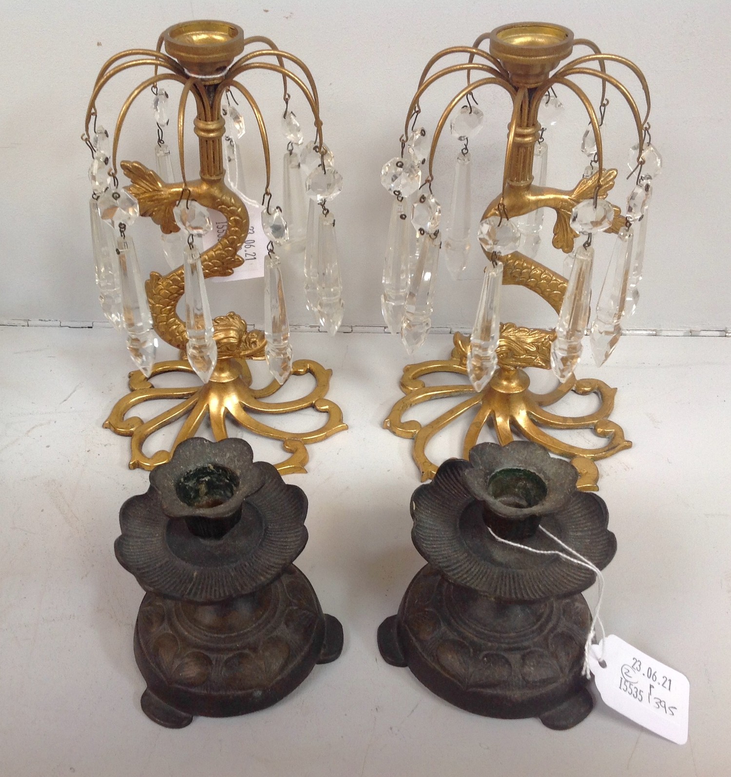 A pair of Regency gilt bronze lustres, raised on stylised dolphin bases to hand cut splayed and