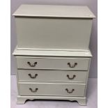 A painted, 'eau de nil' colour chest of three long, graduated drawers with brass handles, raised
