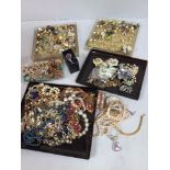 A collection of assorted costume jewellery including pearls, beads, chains and brooches etc.