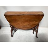A Victorian mahogany drop leaf gate leg Sutherland table with fluted turned legs on brass castors