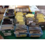 Eight boxes of various sizes containing approximately 3,800 postcards ' most put in county and