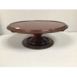 An early 20th century mahogany 'Lazy Susan', of typical form with rotating, circular top, raised