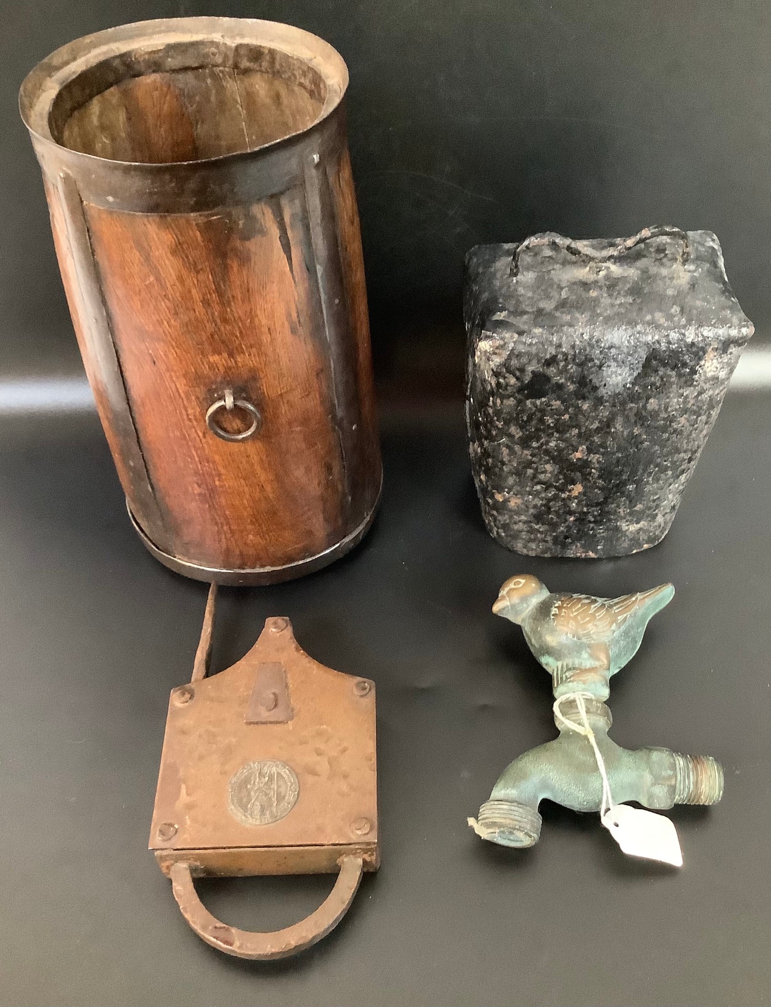 A brass part tap fitting with robin finial, together with a large cast iron cow bell, an unusual