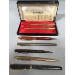 A cased set of gold-plated Parker pens, together with five other various pens