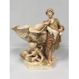 A Royal Dux porcelain centrepiece vase modelled as a classical male figure wearing a goatskin,