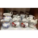 SECTION 7. Twelve various 19th century ceramic jugs including four hand-painted floral jugs, a