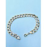 A 9ct gold curb link bracelet, weighs 10.5 grams.