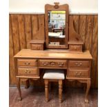 A pine dressing table, the raised back with central swinging mirror and two drawers, above three