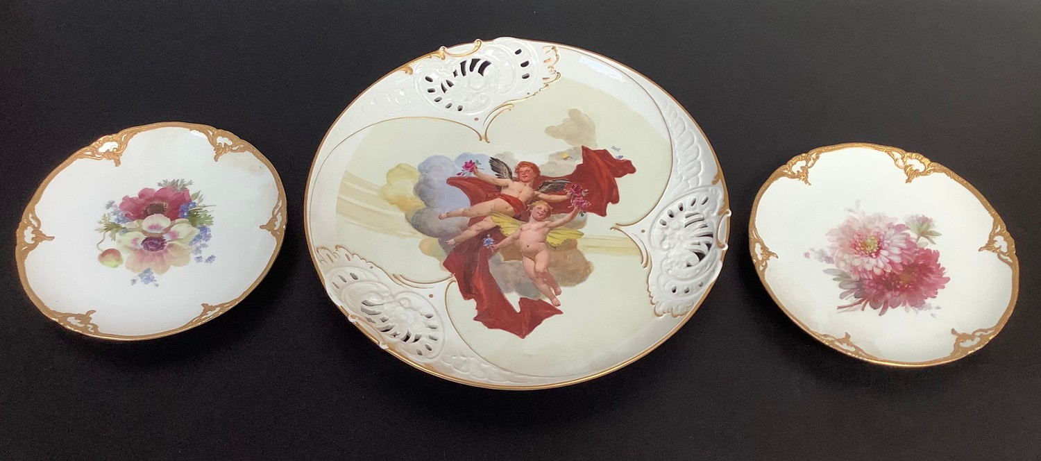 A large Meissen porcelain circular wall charger with pierced rim and painted with cherubs, 36cm