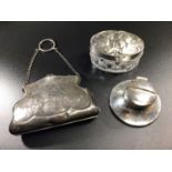 A silver ladies purse of shaped form with foliate engraving surrounding central cartouche,