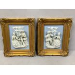 A pair of relief moulded ceramic panels, each with an 18th century courting couple conversing and