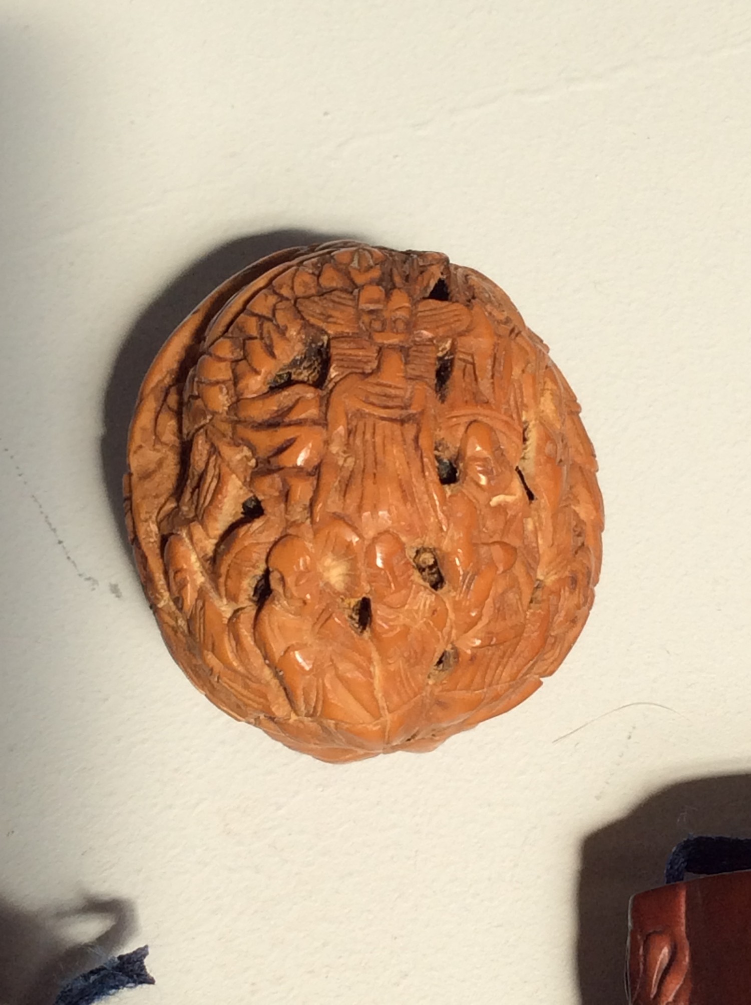 A Japanese 'Thousand faces' carved walnut shell, together with two various stained cherrywood - Image 2 of 3