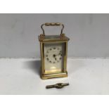 A Mappin & Webb carriage clock, the top with exposed platform escapement, above a white dial with